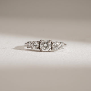 Front view of Modern Five Stone Diamond Engagement Ring against white background. Designed in 14KT hallmarked white gold, size 12, featuring EF colour, VVS clarity lab grown diamonds totaling 0.97 carats, with a 0.47-carat solitaire. Weight 2.52 grams, price INR 50,000–1,00,000.