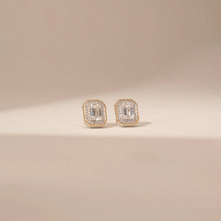 Front view of 14KT Yellow Gold diamond earrings, featuring rectangular step-cut diamonds with a delicate diamond halo.