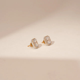 Angled view of 14KT Yellow Gold diamond earrings, featuring rectangular step-cut diamonds with a delicate diamond halo.