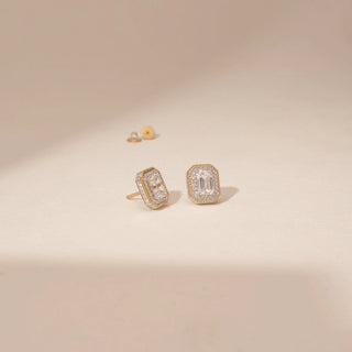 Angled view of 14KT Yellow Gold diamond earrings, featuring rectangular step-cut diamonds with a delicate diamond halo.