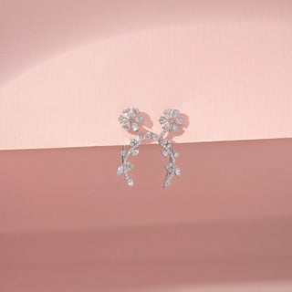 Front view of Floral Vine Drop Diamond Earrings in 14KT White Gold, featuring flower motifs and leaf-shaped diamonds.