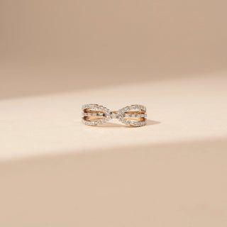 Front view of a 14KT Yellow Gold diamond ring with an infinity-inspired crossover design and diamond-set bands.