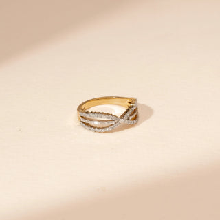 Side view of a 14KT Yellow Gold diamond ring with an infinity-inspired crossover design and diamond-set bands.