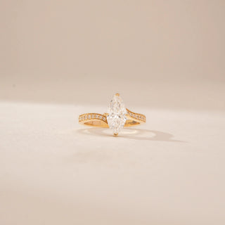 Front view of a 14KT Yellow Gold diamond ring, featuring marquise-cut diamond and a diamond-set curved band.