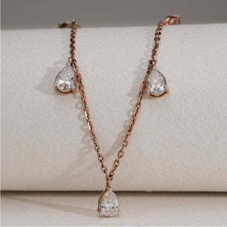 Full view of Elegant Diamond Drop Necklace in 14 KT rose gold, adorned with multiple pear-cut EF VVS diamonds totaling 2.16 carats, including a 0.50-carat solitaire. Necklace size is 16 with a secure fish lock closure, and the product weighs 4.75 grams, combining elegance with comfort.