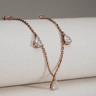 Rose gold Elegant Diamond Drop Necklace, 14 KT hallmarked, shown at an angled view highlighting pear-cut EF VVS diamonds set along the delicate chain. Total diamond weight is 2.16 carats, with a 0.50-carat solitaire. Necklace size is 16, secured with a fish lock, and weighs 4.75 grams.