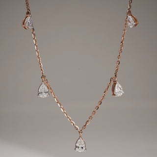 Elegant Diamond Drop Necklace is a sophisticated and timeless piece that adds a touch of luxury to any ensemble. This exquisite necklace is crafted in rose gold and has a hallmarked 14 KT gold metal purity, with a size of 16. It features a secure fish lock to keep the product safe. The diamonds utilized in this piece are of excellent cut, EF Colour, and VVS Clarity, with a total weight of 2.16 carats, including a solitaire of 0.50 carats. The product weighs 4.75 grams, ensuring comfort and elegance.