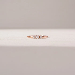Front view of Trio Diamond Ring in 14KT Rose Gold, featuring a round centre lab-grown diamond with two round side stones.