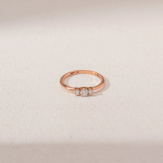 Top view of Trio Diamond Ring in 14KT Rose Gold, featuring a round centre lab-grown diamond with two round side stones.