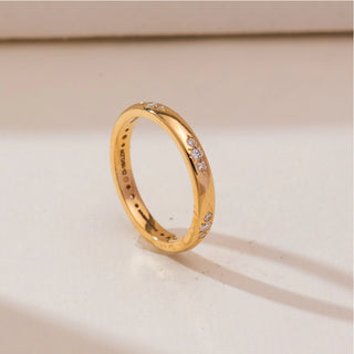 Angled view of Celestial Starburst Gold Diamond Band in 14KT yellow gold, featuring round diamonds set in a subtle starburst pattern along a sleek polished band.