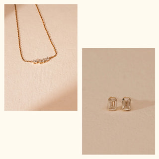 Minimal lab-grown diamond necklace with emerald-cut accents paired with matching emerald-cut stud earrings by Réia, presented as a flat lay on a warm beige surface in soft diffused light.