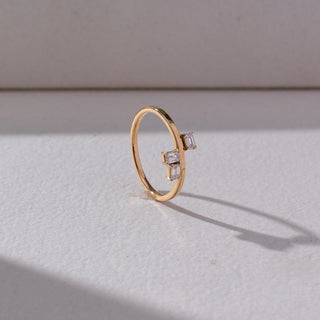 Side view of Baguette Diamond Open Ring in 14KT Yellow Gold, featuring two baguette-cut lab grown diamonds on an open band. Set on a beige backdrop, the design highlights structure and modern elegance.
