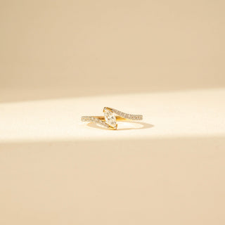 Front view of Marquise Solitaire Diamond Ring in 14KT Yellow Gold, featuring a marquise-cut centre diamond and pavé-set curved bands.