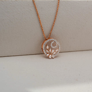 Close-up front view of a rose gold floral circle pendant necklace with pavé-set diamonds and marquise-cut stones, hanging from a delicate chain against a neutral background.