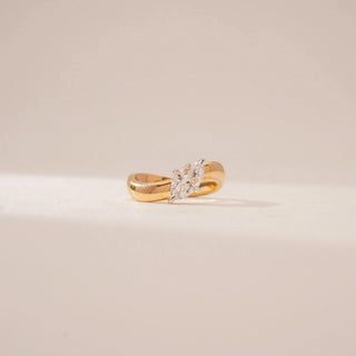 Front view of a marquise diamond ring in 14KT Yellow Gold, featuring a wide polished band and four-prong setting against a beige backdrop.
