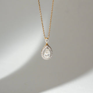Front view of Teardrop Halo Diamond Pendant Necklace in 14KT Yellow Gold, featuring a pear-shaped lab grown diamond encircled by a halo with a round accent above. Set on a neutral backdrop, the design highlights brilliance and elegance.