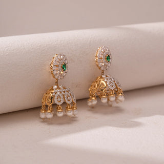 Side view of the Royal Emerald Pearl Jhumka Earrings in 14KT yellow gold, featuring pear-shaped diamonds, emerald-toned center stones, and pearl danglers. The design reflects regal elegance and grandeur.
