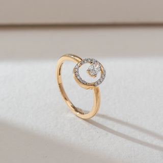 Side angled view of oval halo diamond ring in yellow gold, featuring a centred oval lab-grown diamond within an open circular frame lined with round diamonds. Set on a soft neutral backdrop, it highlights refined sparkle.