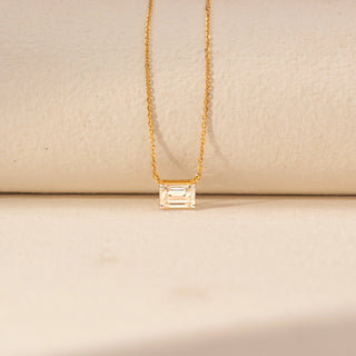 Close-up view of Emerald-Cut Solitaire Diamond Pendant in 14KT Yellow Gold, featuring a bezel-set lab-grown diamond on a fine chain.
