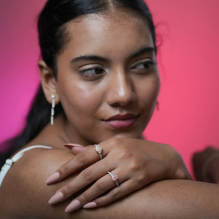 Model wearing Reia Rose Glow Radiant Diamond Ring and matching pieces, showcasing the blush pink centre stone against a soft pink backdrop, symbolising refined elegance and individuality.