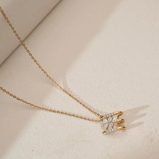 Top angled view of Triple Bar Floral Diamond Pendant in 14KT Yellow Gold, featuring three diamond-accented gold bars and a pear-shaped floral cluster centre on a fine gold chain.