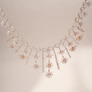 Front view of a floral lab-grown diamond necklace in 14KT Rose Gold, featuring cascading marquise and round diamond motifs with elegant drop details. Captured against a beige backdrop, the statement design radiates brilliance.