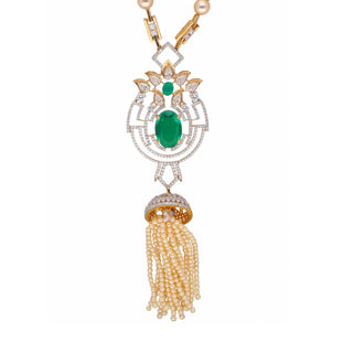 A close view of the female necklace of size 22 secured with a spring lock, displayed on a white background, showcasing a 14 KT yellow gold pearl necklace having a lab-grown white pearl chain along with a pendant featuring an intricate design made out of green Emerald and diamonds with a total of 3.79 carats having a sparkling green Emerald at its centre suspended by a tassel of pearls weighing 24.3 grams for an elegant vintage look perfect for a special occasion.