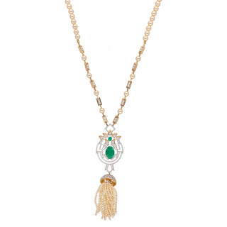 A zoomed-out view of the female necklace of size 22 secured with a spring lock, displayed on a white background, showcases a 14 KT yellow gold pearl necklace having a lab-grown white pearl chain along with a pendant featuring an intricate design made out of green Emerald and diamonds with a total of 3.79 carats having a sparkling green Emerald at its centre suspended by a tassel of pearls weighing 24.3 grams for an elegant vintage look perfect for a special occasion.