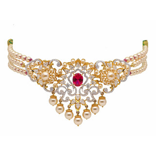 A zoomed-out view of the female necklace of size 16 secured with a spring lock, on a white background, showcasing a 14 KT yellow gold choker necklace made of lab-grown white pearls features a centrepiece with a striking red Ruby with a total weight of 20.77 grams surrounded by diamond studded intrinsic lattice work with a total of 3.8 carats finished with hanging pearl drops making it a luxurious statement piece.