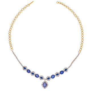 A front-side view of the female necklace of size 16, on a white background, showcasing a 14 KT yellow gold necklace secured with a spring lock featuring a symmetrical pattern of lab-grown blue Sapphires with a total product weight of 29.406 grams in a diamond-studded setting with a total of 2.37 carat finished with a central blue Sapphire hanging at the bottom creating a classy look for any occasion.