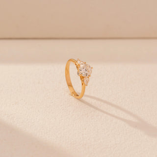 Angled view of Floral Solitaire Diamond Ring in 14KT Yellow Gold, featuring a round centre diamond with marquise diamond accents.