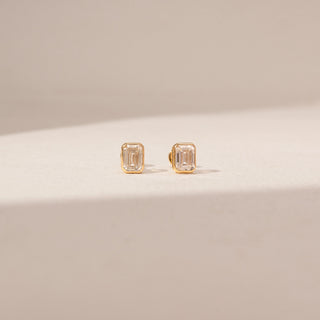 Front view of Emerald Cut Diamond Stud Earrings in 14KT Yellow Gold, featuring rectangular lab-grown diamonds in bezel settings.
