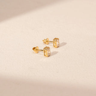 Side view of Emerald Cut Diamond Stud Earrings in 14KT Yellow Gold, featuring rectangular lab-grown diamonds in bezel settings.