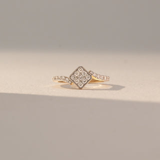 Front view of Square Cluster Diamond Ring in 14KT Yellow Gold, featuring round lab grown diamonds in a square cluster with pavé-set band. Set on a beige backdrop, the design highlights sparkle and structured elegance.
