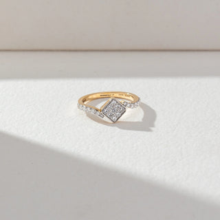 Top view of Square Cluster Diamond Ring in 14KT Yellow Gold, featuring round lab grown diamonds in a square cluster with pavé-set band. Set on a beige backdrop, the design highlights symmetry and brilliance.
