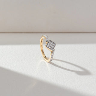Side view of Square Cluster Diamond Ring in 14KT Yellow Gold, featuring round lab grown diamonds in a square cluster with pavé-set band. Set on a beige backdrop, the design highlights structure and sparkle.
