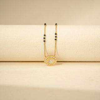 Front view of Oval Diamond Mangalsutra in 14KT Yellow Gold, featuring a floral halo and black bead chain.