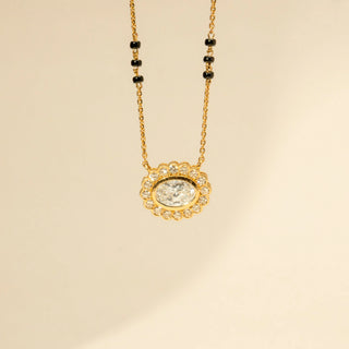 Close-up view of Oval Diamond Mangalsutra in 14KT Yellow Gold, featuring a floral halo and black bead chain.