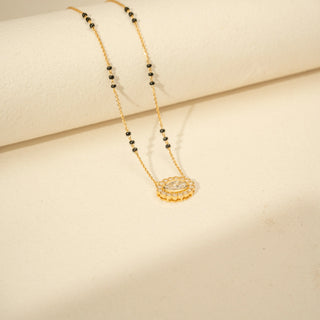 Side view of Oval Diamond Mangalsutra in 14KT Yellow Gold, featuring a floral halo and black bead chain.