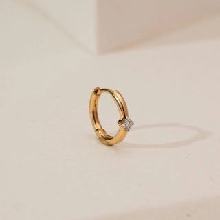 Side angled view of Minimalist Round Solitaire Diamond Nosepin in yellow gold, featuring a single round lab-grown diamond set in a classic solitaire mount against a neutral background.