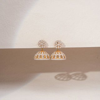 Front view of floral lab-grown diamond jhumka earrings in 18KT Yellow Gold, featuring marquise diamond flower studs with openwork dome drops. Captured against a beige backdrop, the intricate design radiates timeless elegance.