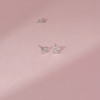 Angled view of a 14KT White Gold diamond stud earring, featuring an oval centre diamond and prong setting.