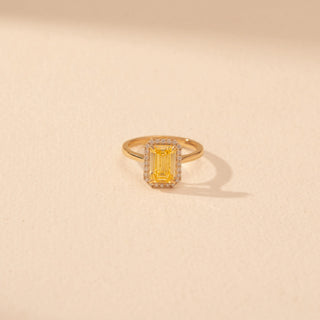 Top view of Emerald-Cut Yellow Diamond Halo Ring in 14KT Yellow Gold, featuring a yellow emerald-cut diamond with a pavé halo.