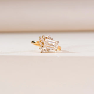 Side angle view of Emerald Cut Cluster Diamond Ring in 14KT white gold, featuring a central emerald-cut diamond with marquise and round cluster accents in a floral-inspired design.