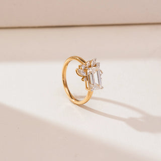 Side profile view of Emerald Cut Cluster Diamond Ring in 14KT white gold, showcasing a raised emerald-cut centre diamond with marquise and round cluster accents on a polished band.