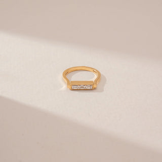 Top view of a 14KT Yellow Gold diamond ring featuring a rectangular bezel setting with baguette-cut and round diamond accents.
