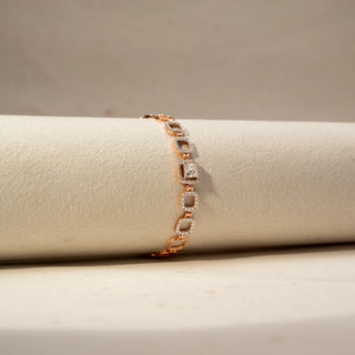Side view of a diamond bracelet in 14 KT Rose Gold, featuring repeating circular pavé-set diamond motifs linked in a graceful linear design, displayed against a soft beige backdrop.
