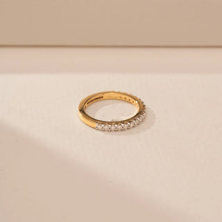 Side view of a 14KT Yellow Gold diamond ring with a full diamond-set band featuring round diamond accents.