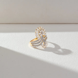 Angled view of Floral Cluster Diamond Ring in 14KT Yellow Gold, featuring pear-shaped lab grown diamonds forming a bloom with pavé-set bands. Set on a beige backdrop, the design highlights depth and intricate brilliance.
