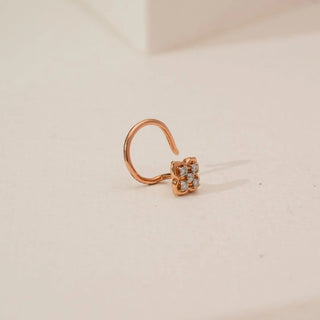 Side angle view of floral cluster lab-grown diamond nosepin in yellow gold, featuring four round diamonds set in a compact flower motif with a smooth curved hook design.